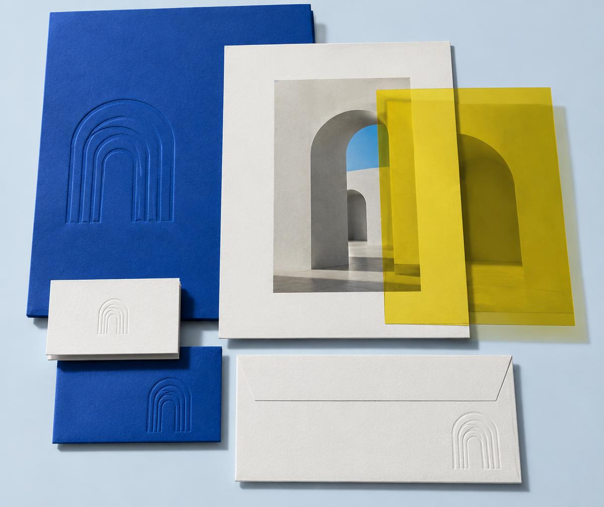 Blue and white identity stationery with an architectural arch motif